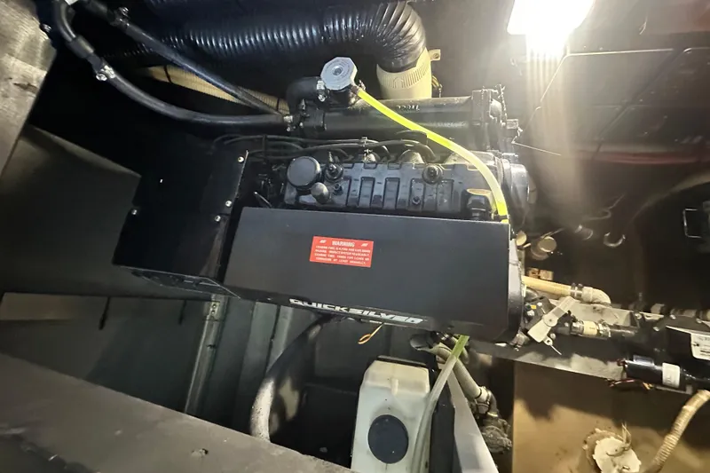 Slide: The Image of Engine compartment of a 1990 Sea Ray 380 Aft Cabin boat, featuring Quicksilver components. - 67