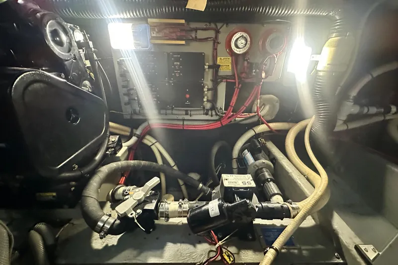 Slide: The Image of Engine room of 1990 Sea Ray 380 Aft Cabin with visible wiring and components. - 68