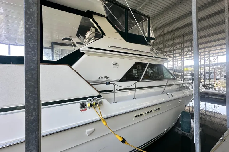 Slide: The Image of 1990 Sea Ray 380 Aft Cabin yacht docked in covered marina. - 8