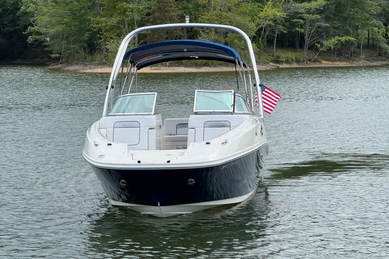 Slide: The Image of 2009 Sea Ray 280 Sundeck boat on a serene lake with American flag. - 17