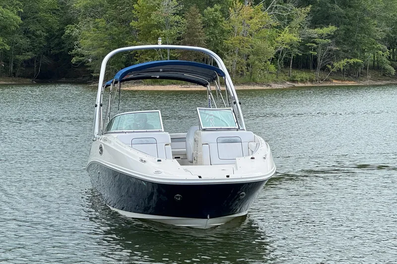 Slide: The Image of 2009 Sea Ray 280 Sundeck boat on a serene lake with lush green trees. - 19