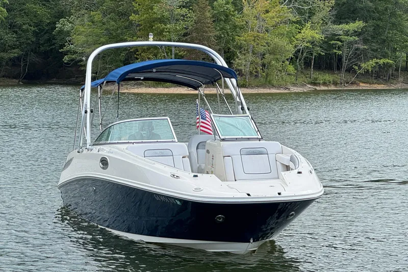 Slide: The Image of 2009 Sea Ray 280 Sundeck boat on a serene lake with lush green trees. - 20