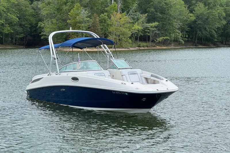 Slide: The Image of 2009 Sea Ray 280 Sundeck boat on a serene lake with lush green trees. - 22