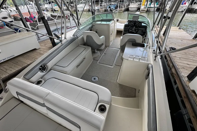 Slide: The Image of 2009 Sea Ray 280 Sundeck interior with seating and helm, docked at marina. - 29