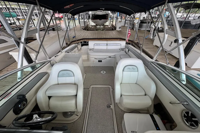Slide: The Image of 2009 Sea Ray 280 Sundeck interior with white seating and steering wheel, docked at marina. - 33