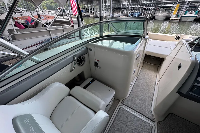 Slide: The Image of 2009 Sea Ray 280 Sundeck interior with seating and storage, docked at marina. - 36