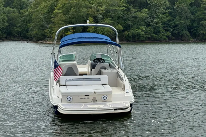 Slide: The Image of 2009 Sea Ray 280 Sundeck boat on a calm lake with lush green trees. - 7