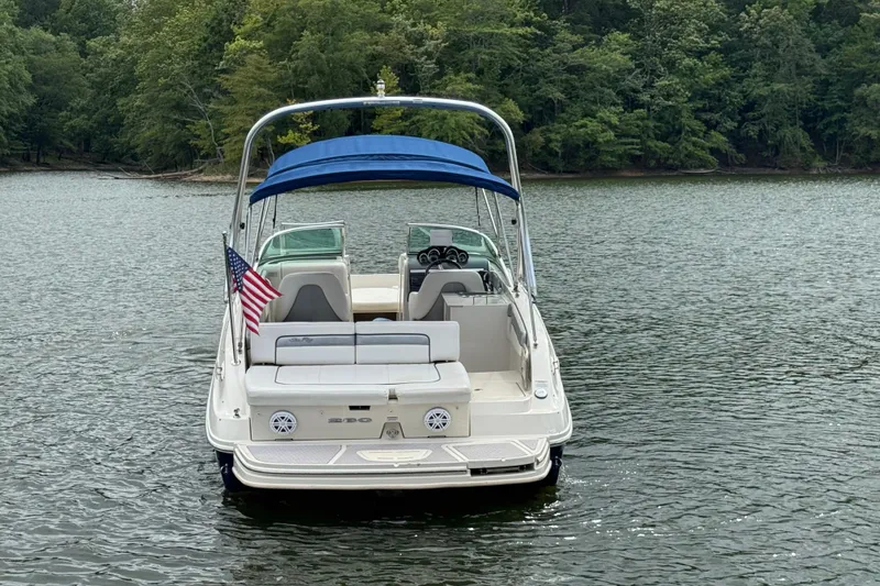 Slide: The Image of 2009 Sea Ray 280 Sundeck boat with blue canopy on a calm lake. - 8