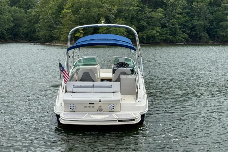 Slide: The Image of 2009 Sea Ray 280 Sundeck boat with blue canopy on a lake. - 9