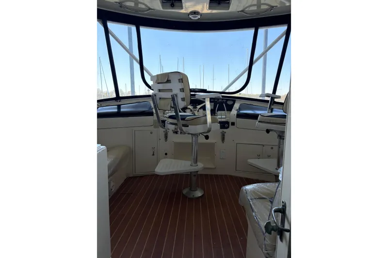 Slide: The Image of Interior view of 1991 Hatteras 52 Cockpit Motor Yacht helm station with seating. - 14