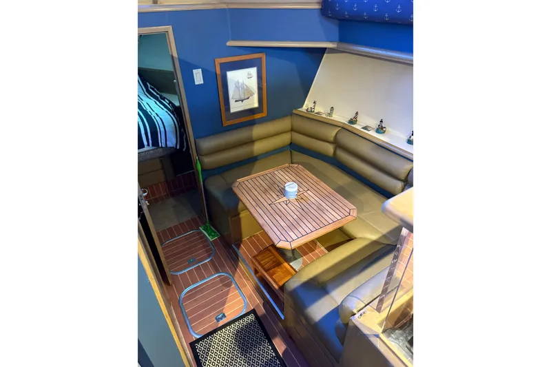 Slide: The Image of Interior of 1991 Hatteras 52 Cockpit Motor Yacht with cozy seating and nautical decor. - 15