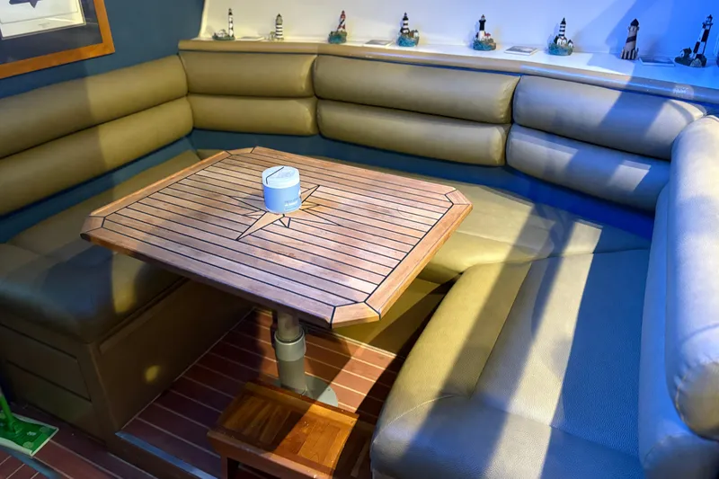 Slide: The Image of Interior of 1991 Hatteras 52 Cockpit Motor Yacht with cozy seating and wooden table. - 20