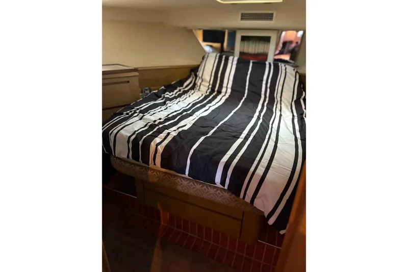 Slide: The Image of Interior cabin of 1991 Hatteras 52 Cockpit Motor Yacht with striped bedding. - 21