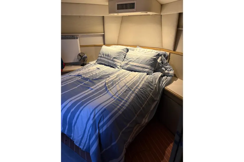 Slide: The Image of Cozy bedroom in 1991 Hatteras 52 Cockpit Motor Yacht with striped bedding. - 24