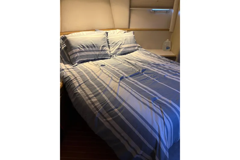 Slide: The Image of Cozy bedroom with striped bedding in 1991 Hatteras 52 Cockpit Motor Yacht. - 26