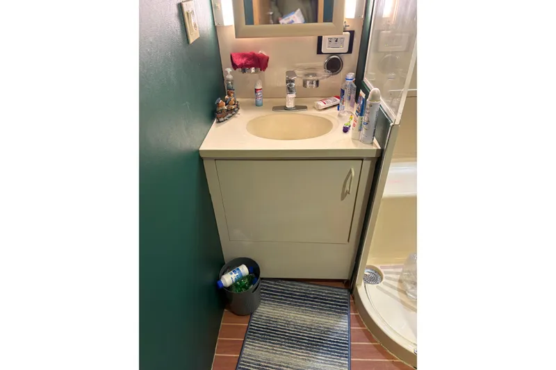 Slide: The Image of Bathroom vanity on 1991 Hatteras 52 Cockpit Motor Yacht with sink and toiletries. - 28