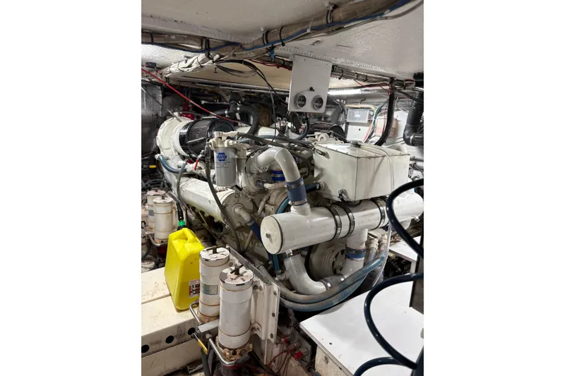 Slide: The Image of Engine room of 1991 Hatteras 52 Cockpit Motor Yacht, showcasing mechanical components. - 32