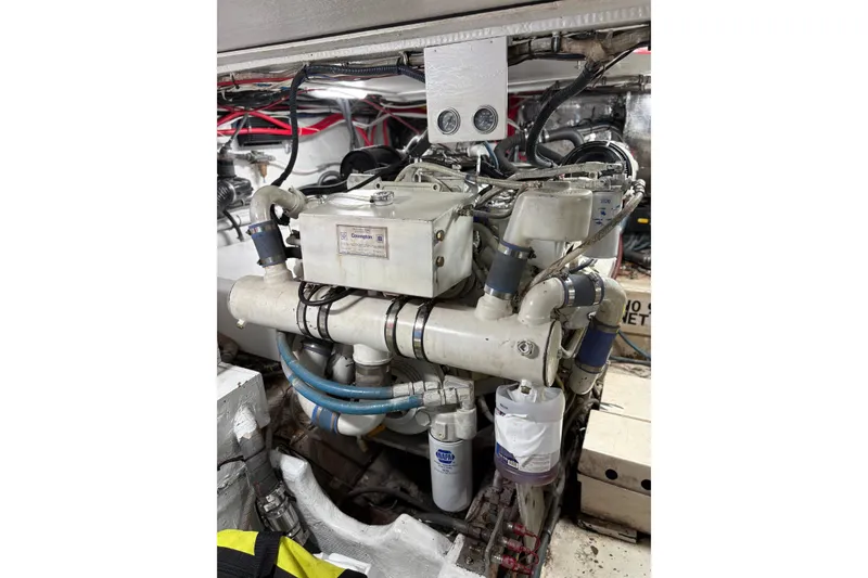 Slide: The Image of Engine room of a 1991 Hatteras 52 Cockpit Motor Yacht, showcasing mechanical components. - 33