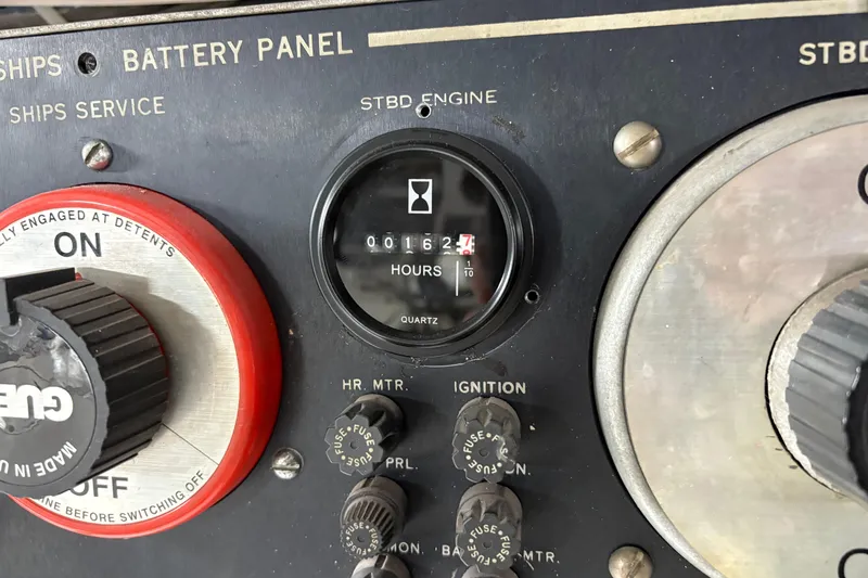Slide: The Image of Battery panel of 1991 Hatteras 52 Cockpit Motor Yacht showing engine hours and controls. - 35