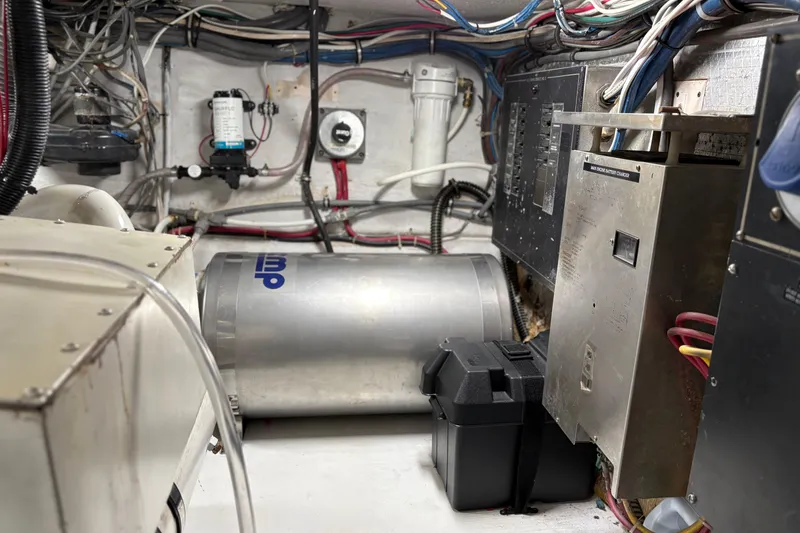 Slide: The Image of Engine room of a 1991 Hatteras 52 Cockpit Motor Yacht with wiring and equipment. - 36