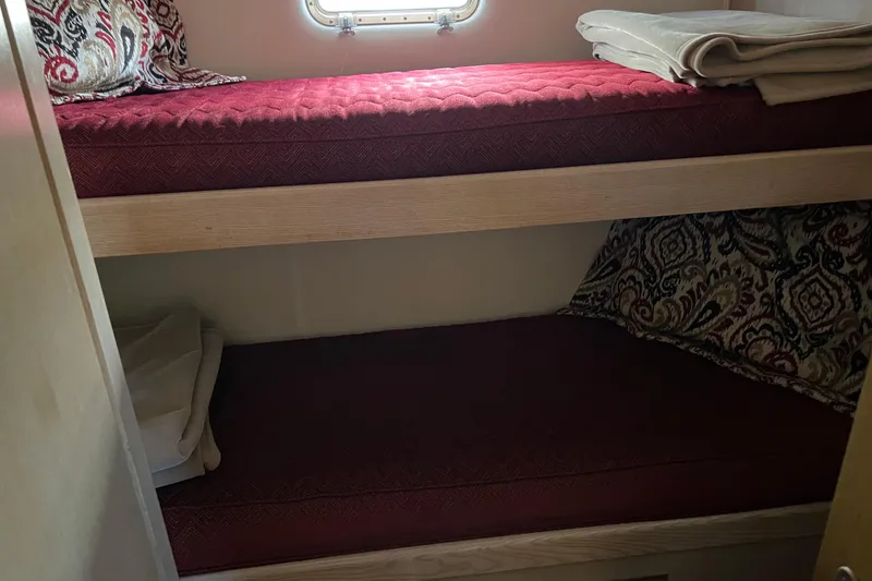 Slide: The Image of Bunk beds in 1991 Hatteras 52 Cockpit Motor Yacht cabin with red bedding. - 8