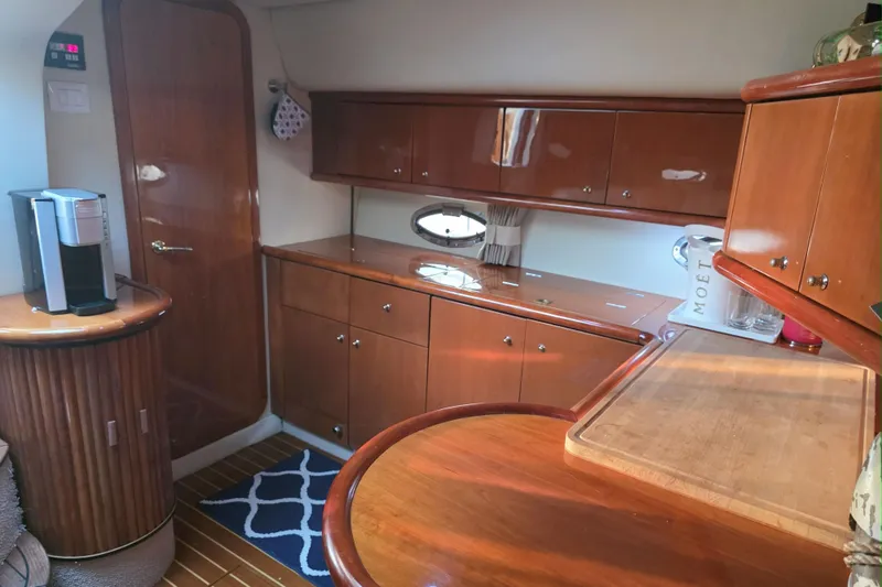 Slide: The Image of Luxurious interior of 2001 Sunseeker Camargue 44 yacht with elegant wood finishes and cozy seating. - 9