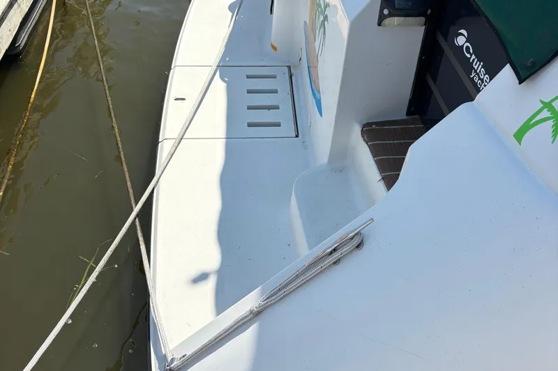 Slide: The Image of 1989 Cruisers 3670 yacht deck with mooring ropes and logo visible. - 7