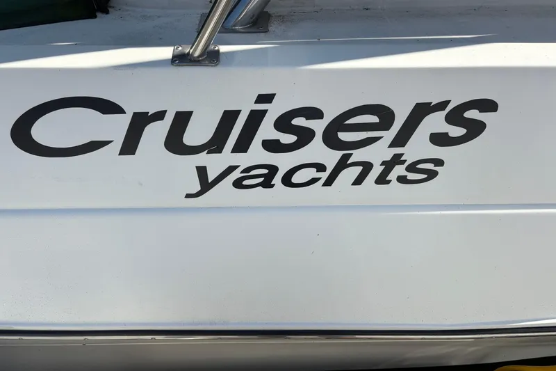 Slide: The Image of 1989 Cruisers 3670 yacht logo on white surface. - 4