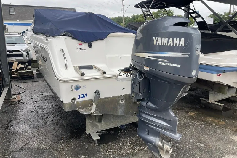 Slide: The Image of 2009 Sea Hunt Escape 220 LE boat with Yamaha 150 four-stroke engine, docked outdoors. - 3