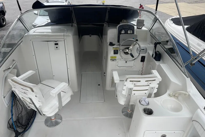 Slide: The Image of 2009 Sea Hunt Escape 220 LE boat interior with steering wheel and seating. - 5