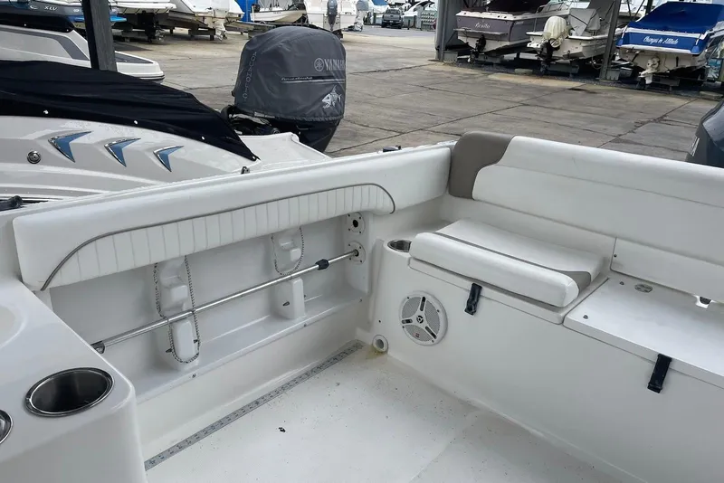 Slide: The Image of 2009 Sea Hunt Escape 220 LE boat interior with white seating and storage compartments. - 7
