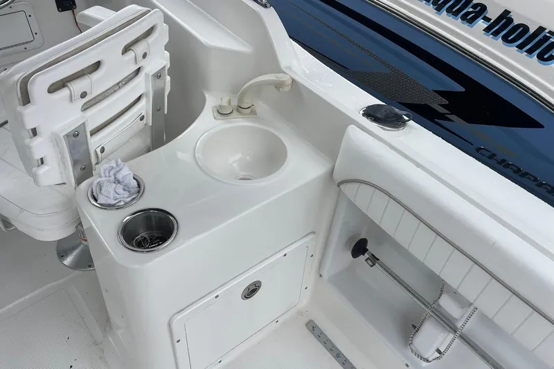 Slide: The Image of 2009 Sea Hunt Escape 220 LE boat interior with sink and seating area. - 9