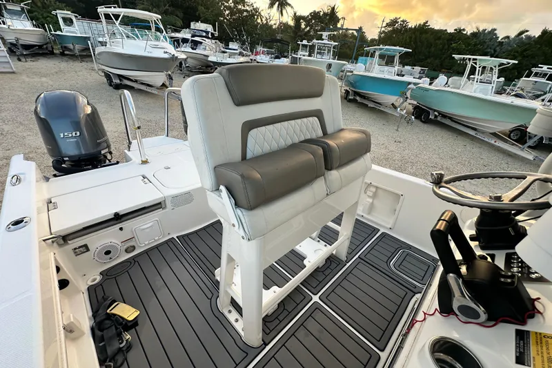 Slide: The Image of 2022 World Cat 235 CC boat interior with seating and steering wheel. - 13