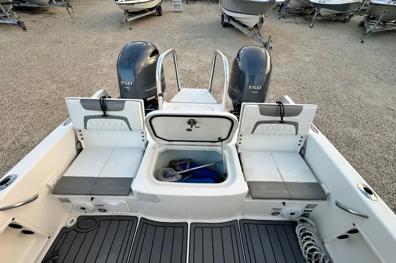 Slide: The Image of 2022 World Cat 235 CC boat with dual engines and open storage compartment. - 15