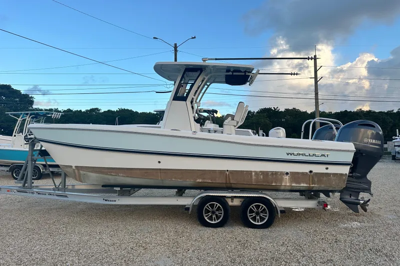 Slide: The Image of 2022 World Cat 235 CC boat on trailer, featuring dual Yamaha engines. - 6