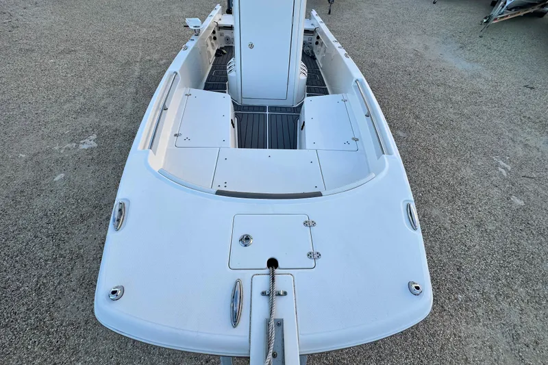 Slide: The Image of 2022 World Cat 235 CC boat deck, featuring spacious layout and storage compartments. - 8