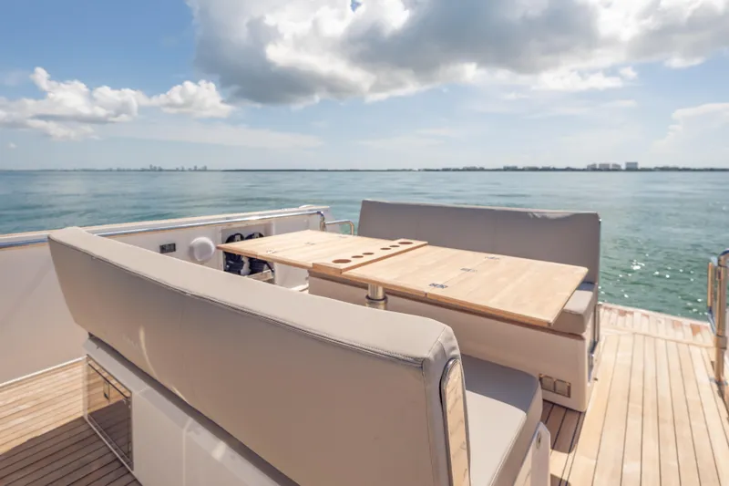 Slide: The Image of Luxury seating area on 2021 Fjord 40 Open yacht with ocean view. - 12