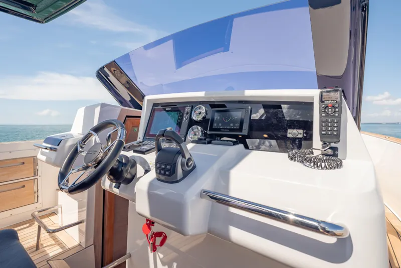 Slide: The Image of Helm of 2021 Fjord 40 Open yacht with modern navigation equipment and steering wheel. - 16