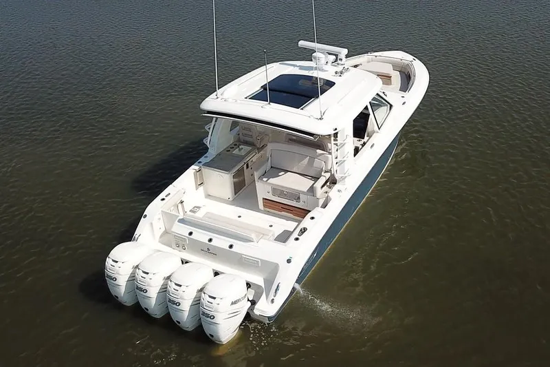 Slide: The Image of Manufacturer Provided Image: 2019 Boston Whaler 380 Realm boat with quad outboard engines on water. - 2