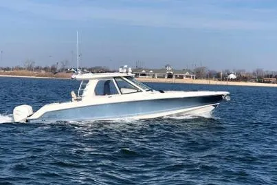 Slide: The Image of 2019 Boston Whaler 380 Realm cruising on open water, side view. - 3