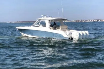 Slide: The Image of 2019 Boston Whaler 380 Realm cruising on open water, showcasing sleek design and powerful engines. - 9