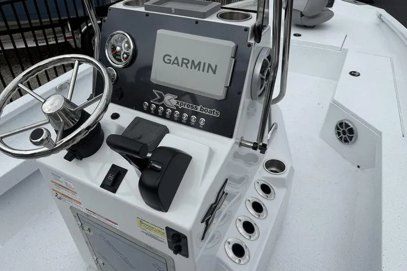 Slide: The Image of 2026 Xpress H22B boat console with Garmin navigation system and steering wheel. - 12
