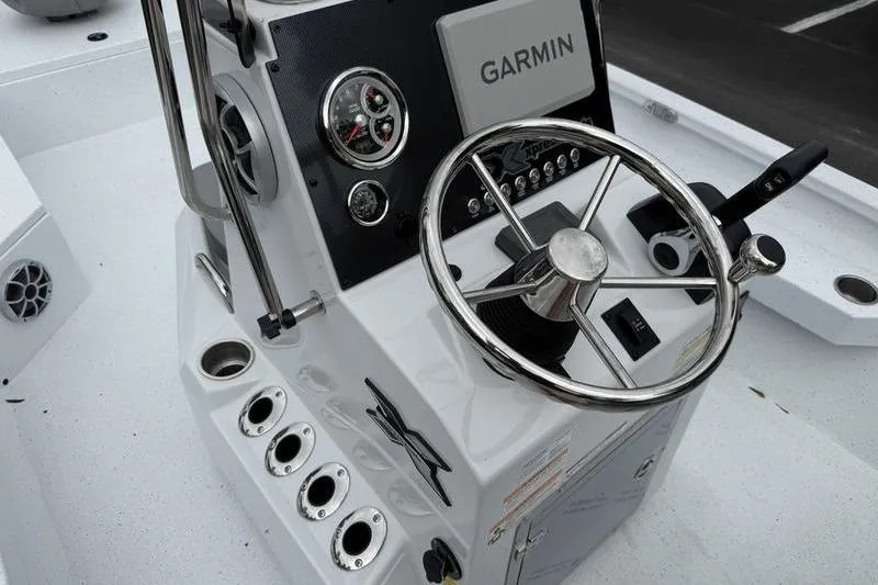 Slide: The Image of 2026 Xpress H22B boat console with Garmin navigation and steering wheel. - 13
