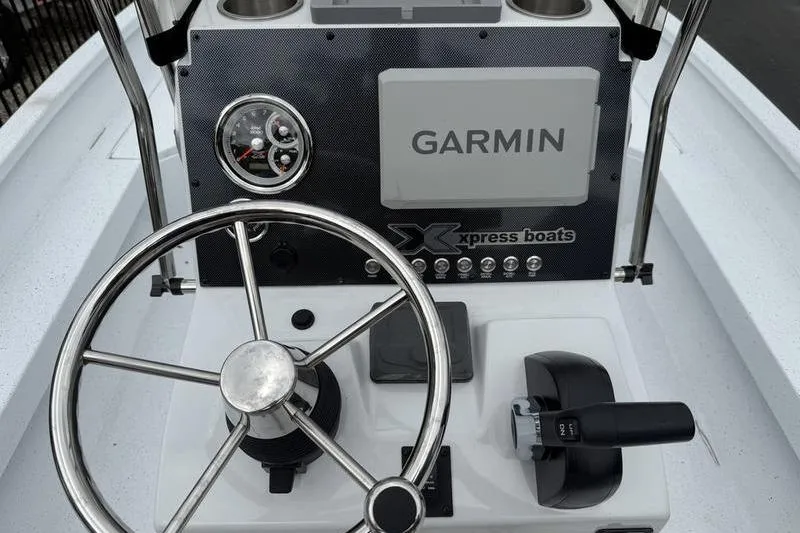 Slide: The Image of 2026 Xpress H22B boat dashboard with Garmin navigation and steering wheel. - 14