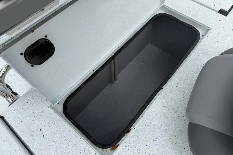 Slide: The Image of Open storage compartment on 2026 Xpress H22B boat deck. - 17