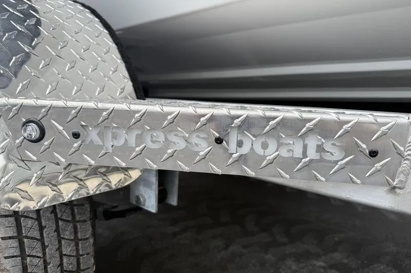 Slide: The Image of Close-up of 2026 Xpress H22B boat trailer with diamond plate design. - 19