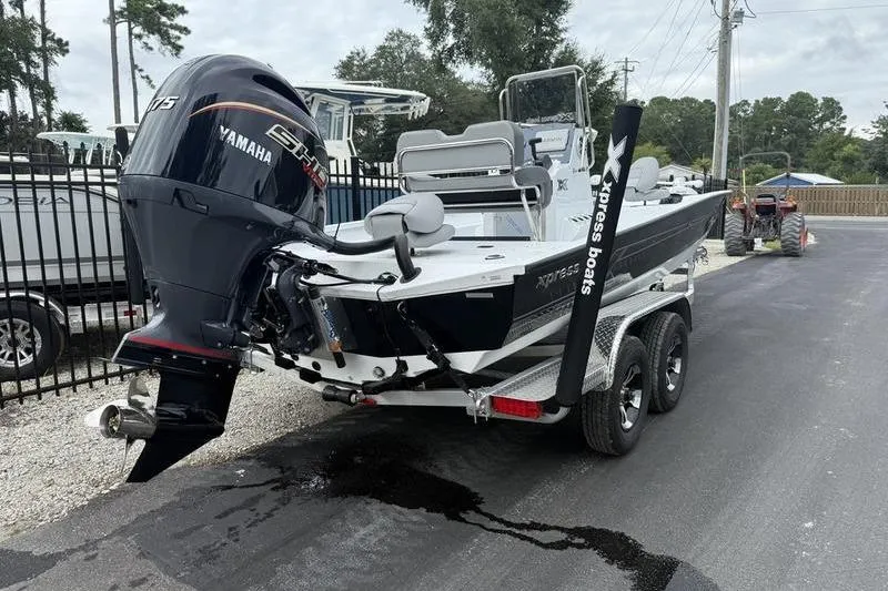 Slide: The Image of 2026 Xpress H22B boat with Yamaha engine on trailer, parked outdoors. - 4