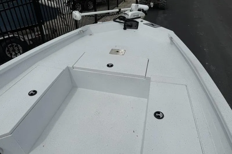 Slide: The Image of 2026 Xpress H22B boat deck with storage compartments and trolling motor. - 6