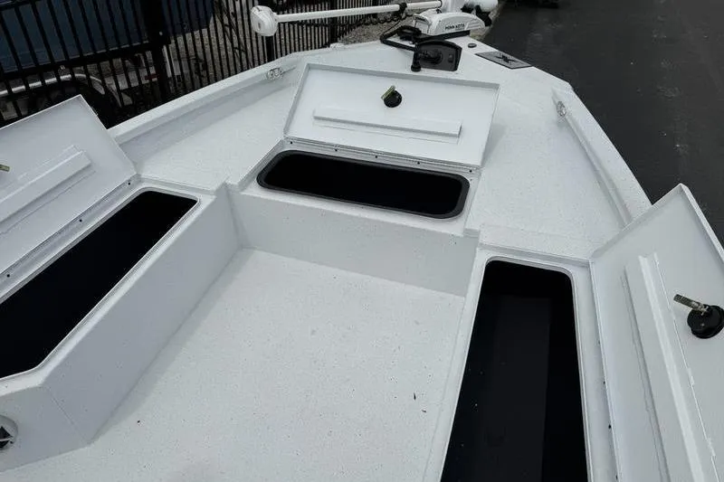 Slide: The Image of 2026 Xpress H22B boat deck with open storage compartments. - 8