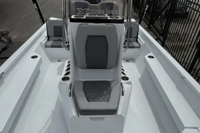 Slide: The Image of 2026 Xpress H22B boat interior with gray seating and cup holders. - 9